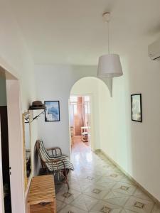 a hallway with a mirror and a chair in a room at House on the beach in Lido Marini