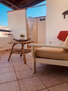 a room with a table and a bench and a window at House on the beach in Lido Marini