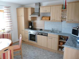a kitchen with wooden cabinets and a sink at Ferienhaus Anke - Ausseerland Salzkammergut in Pichl bei Aussee