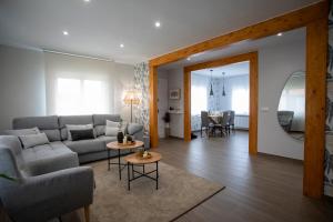 a living room with a couch and a table at As Lavandas, Sober in Lobios