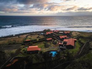 an aerial view of a resort by the ocean at Kuanza Nature Experience, Fajã do Belo in Fajã da Caldeira de Santo Cristo