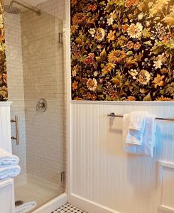 a bathroom with a shower and a painting on the wall at North Hero House Inn and Resort in North Hero +177 photos