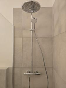 a shower with a shower head in a bathroom at LakeView LakeComo, CIPRESSO 2, 4Seasons, Terrace, 30m to Lake! by STAYHERE-LAKECOMO in Acquaseria
