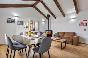 a living room with a table and chairs and a couch at Kuanza Nature Experience, Fajã do Belo in Fajã da Caldeira de Santo Cristo
