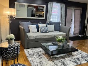 a living room with a couch and a coffee table at NY - NJ Tennis Suites - Sleeps 40 - 15 Mins to NYC in Union City