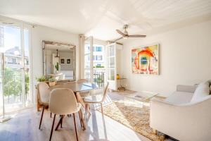 a living room with a dining room table and chairs at Studio Roussel l Bright & AC l Shellter Rentals in Saint-Tropez