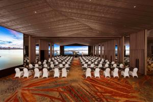 a banquet hall with white chairs and a large room at Pan Pacific Hanoi in Hanoi