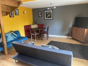 a living room with a couch and a table at Ye Old Sun Inn, Barn Studio in Bilbrough