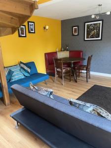 a living room with a couch and a table at Ye Old Sun Inn, Barn Studio in Bilbrough +10 photos