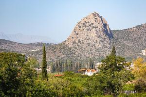 a mountain in the distance with a house and trees at Villa Plaka 16 - 'The Roof' - Drepano, Nafplio in Dhrepanon