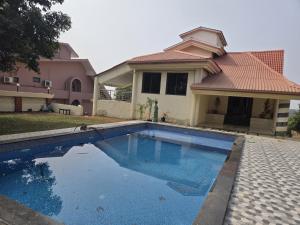 a swimming pool in front of a house at Mountain Breeze Villa in Khandala