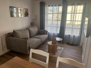 a living room with a couch and a table at Gîte Héloïse in Le Pallet