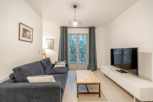 a living room with a couch and a table at La Suite d'Oscar l New, Terrace l Shellter Rentals in Saint-Tropez