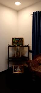 a room with two pictures and a blue curtain at Mandara Villa Hiriketiya in Dickwella +1 photo