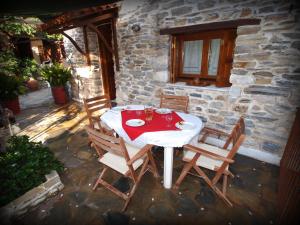 a table and chairs sitting on a patio at Andromahi Studios in Lefokastro