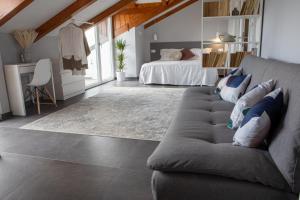 a living room with a couch and a bed at The Cliff Amalfi Coast - Apartment 1 in Pianillo