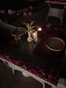 a table with a table cloth with a plant on it at Ritz Resort Lucknow- The Perfect Blend of Business and Leisure in Lucknow