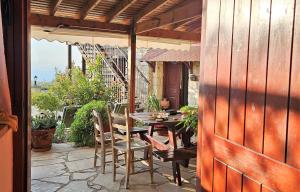a porch with a table and chairs on a patio at HideAway Lasa in Lasa