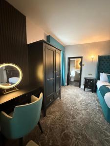 a hotel room with a bed and a mirror at Lyons Woodlands Hall in Ruthin