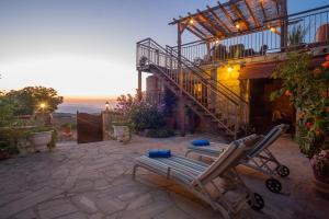 a patio with two lounge chairs and a staircase at HideAway Lasa in Lasa +23 photos