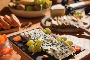 a plate of food with grapes and cheese on a table at Best Western Hotel Lakmi Nice in Nice