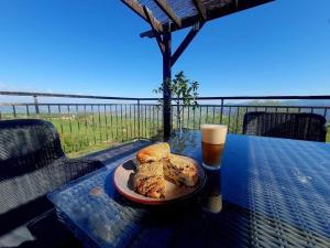 a table with a plate of food and a glass of beer at HideAway Lasa in Lasa