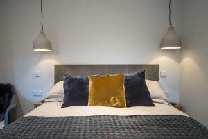 a bedroom with a bed with two pendant lights at Scaw Fell in Cowes