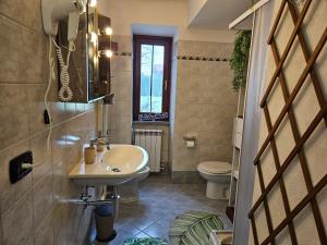 a bathroom with a sink and a toilet at Il Riposo del Viaggiatore by Holiday World in Ternate +16 photos