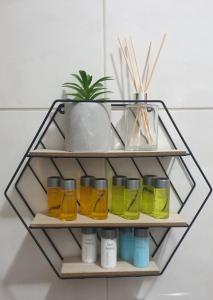 a shelf with four bottles and a plant on it at HideAway Lasa in Lasa