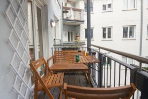 a balcony with two chairs and a table on a balcony at Designer 2 BR Home with Private Balcony in Copenhagen +42 photos