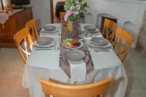 a table with a white table cloth and a plate of food at HideAway Lasa in Lasa