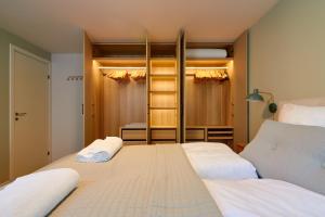 a bedroom with two beds and a closet at Designer 2 BR Home with Private Balcony in Copenhagen