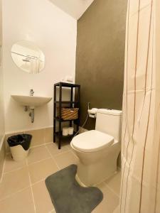 a bathroom with a white toilet and a sink at Houzz 1548 by Houzztelity in Manila +14 photos