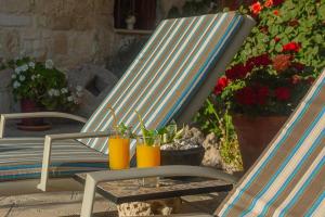 a blue rocking chair with potted plants and flowers at HideAway Lasa in Lasa