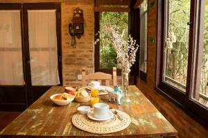 a wooden table with a tea set on it at Posada de las Huellas in Loreto