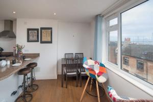 a kitchen and dining room with a table and a window at Composers apartment in Cowes