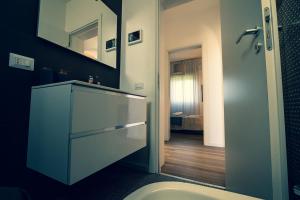 a bathroom with a sink and a mirror at Didi Home Isola Sicilia Villetta fronte spiaggia in Agnone Bagni +65 photos