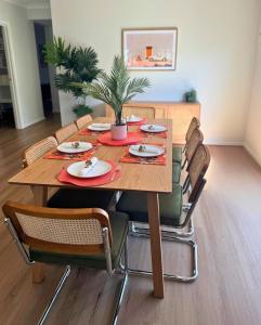 a wooden table with chairs and a plant on it at Yarrawonga by Twin Palms in Yarrawonga