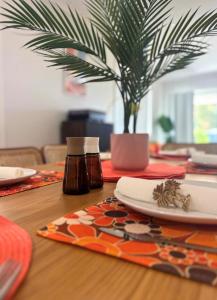 a table with a plate and a potted plant on it at Yarrawonga by Twin Palms in Yarrawonga +24 photos