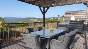 a table and chairs on a deck with a grill at HideAway Lasa in Lasa