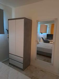 a bedroom with a mirror and a bed and a bed sqor at Modern apartment in Paleo Tsifliki +1 photo