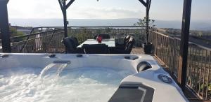 a jacuzzi tub on the deck of a house at HideAway Lasa in Lasa