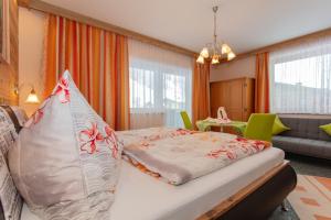 a bedroom with a bed and a living room at Haus Traudi in Rauris