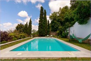 a swimming pool in the yard of a house at QG - stop in Colares