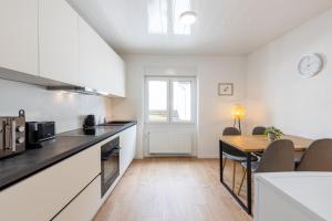 a kitchen with a table and a dining room at Vulkaneifel Cottage in Kottenheim