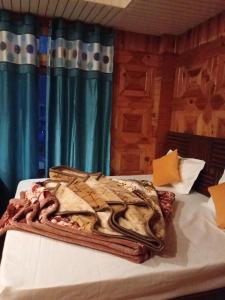 a blanket on top of a bed in a room at Shivaay guest house in Tosh