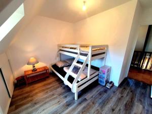 a room with two bunk beds and a lamp at Le pré Colas- la maison néo bretonne in Pordic +12 photos