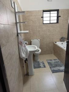 un bagno con un water, un lavandino e una vasca di Kachimam Apartment a Lusaka Altre 12 foto