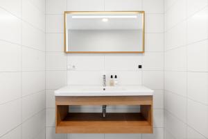 a bathroom with a sink and a mirror at Duinhotel Tien Torens in Zoutelande