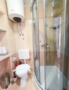 a bathroom with a shower and a toilet and a sink at Private bedroom with bathroom in Baška Voda